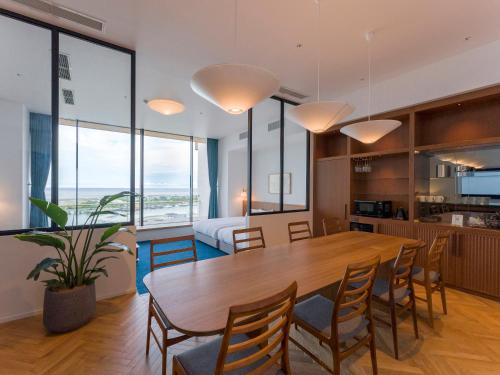 a dining room and living room with a table and chairs at Rakuten STAY Atami in Atami