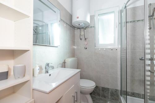 ein Bad mit einem WC, einem Waschbecken und einer Dusche in der Unterkunft Apartments Bella Vista in Krk