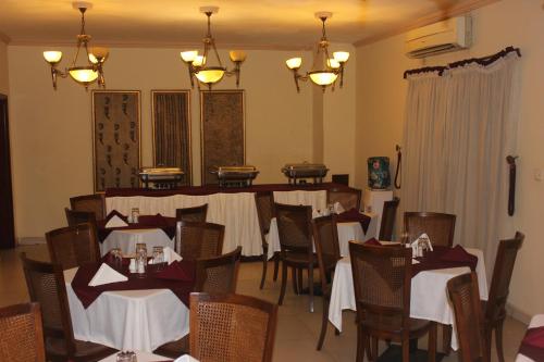 a dining room with tables and chairs with white tablecloths at Carlson Hotel, Osborne Foreshore Phase 2, Ikoyi in Lagos
