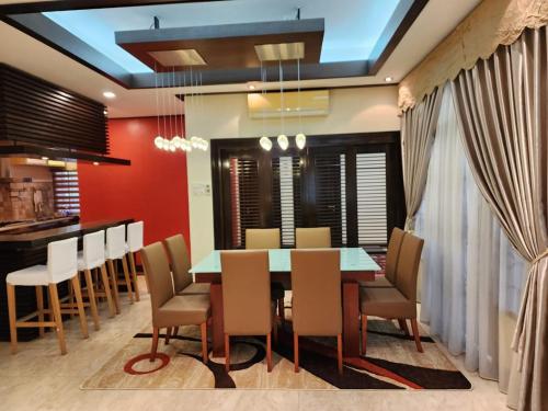 a dining room with a table and chairs at Mawar Singgah in Putrajaya