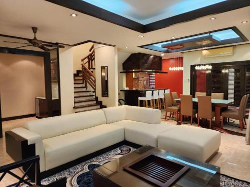 a living room with a white couch and a table at Mawar Singgah in Putrajaya