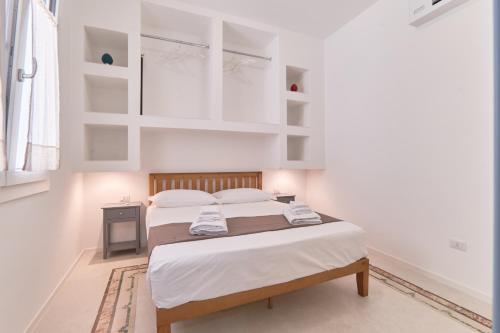 a bedroom with a bed with white walls at Casa dei Nonni in Avetrana