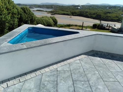 a swimming pool on the roof of a house at Cascade Lodge & Hot Tub in Donegal