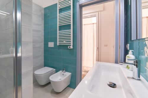 a bathroom with a tub and a toilet and a sink at Casa dei Nonni in Avetrana