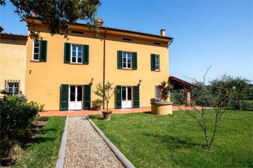 a large yellow house with green shutters at B&B La Casetta in Montecarlo