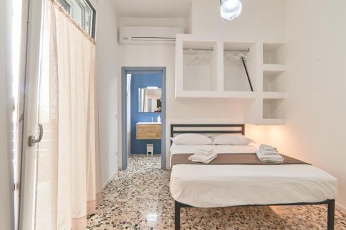 a small bedroom with two beds and a window at Casa dei Nonni in Avetrana
