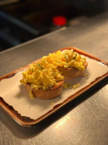 a sandwich with eggs on a plate on a table at The Queens Head Inn in Milton Ernest