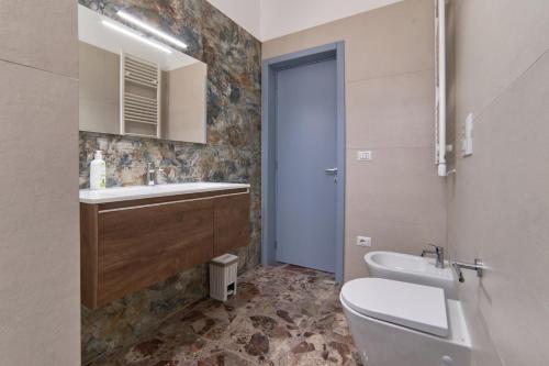 a bathroom with a white toilet and a sink at Casa dei Nonni in Avetrana
