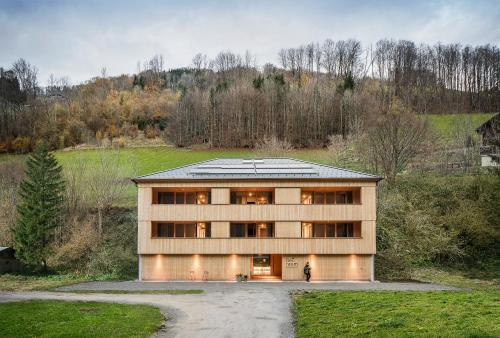 a building with a person standing in front of it at freiraum Apartments in Mellau