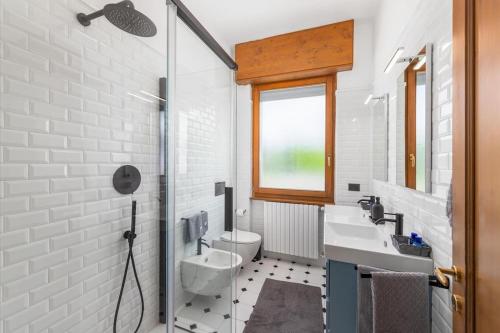 a white bathroom with a sink and a toilet at Vivi Il Lago - Lake View in Cernobbio