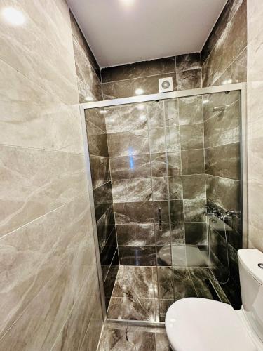 a bathroom with a shower and a toilet at Nice Royal Cıty in Istanbul