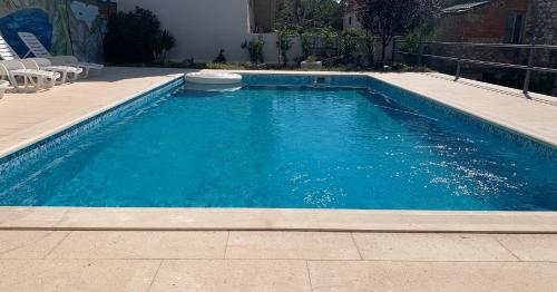 een zwembad met blauw water in een tuin bij Zimmer mit Bad Imotski in Imotski