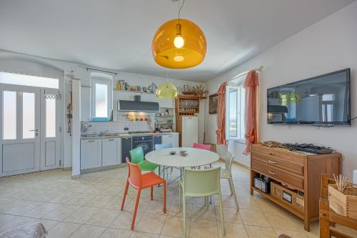 a kitchen and dining room with a table and chairs at Astra 2 Veli Lošinj Harbour View - Happy Rentals in Veli Lošinj