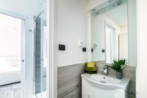 a bathroom with a sink and a mirror at JOIVY Al Duomo guest house in Como
