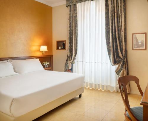 a hotel room with a bed and a window at UNA Hotels Galles Milano in Milan