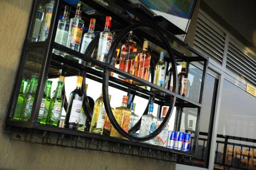 a bunch of bottles of alcohol sitting on a shelf at Galaxy Motel Kampala in Kampala