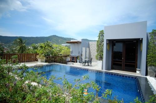a swimming pool in the backyard of a house at Ploen Chaweng by Tolani in Chaweng