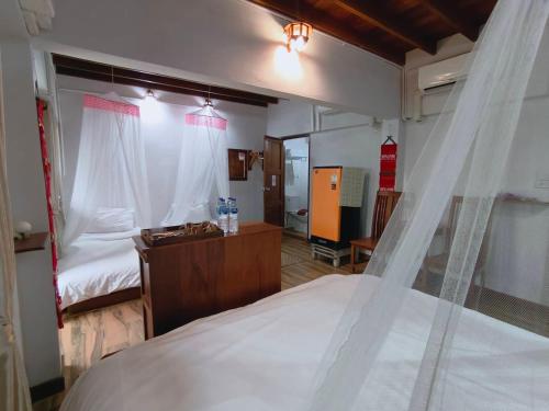 a bedroom with a bed with a mosquito net at Aphilapa Residence in Chiang Mai