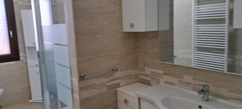 a bathroom with a sink and a toilet and a mirror at Casa Terra Del Sole in Pula