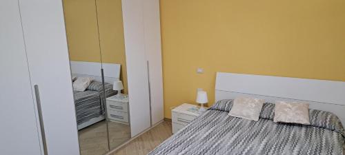 a bedroom with a bed and a large mirror at Casa Terra Del Sole in Pula