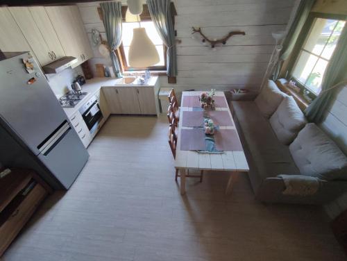 a living room with a couch and a table and a kitchen at EkoStolarnia in Rutka Tartak