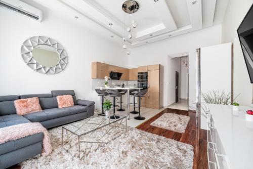 a living room with a couch and a table at Luxury apartment with free garage and balcony in the center in Budapest