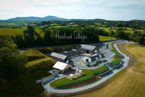 an aerial view of a house on a river at Magical 3-Bed Stone Built Cottage - Sleeps 6 in Ballynahinch
