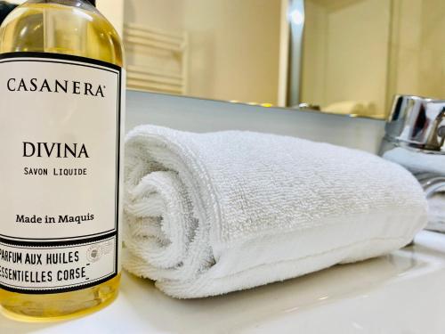 a towel on a counter next to a bottle of wine at Bella Vista Hôtel, Suites & Maisons in Porticcio