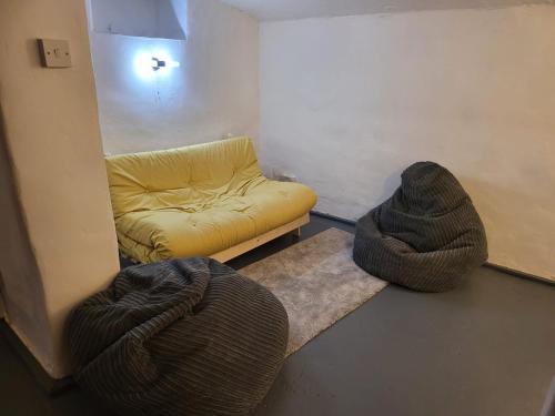 a living room with a couch and two bean bags at Florence Beach House in Weston-super-Mare