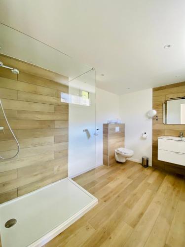 a bathroom with a shower and a toilet and a sink at Bella Vista Hôtel, Suites & Maisons in Porticcio