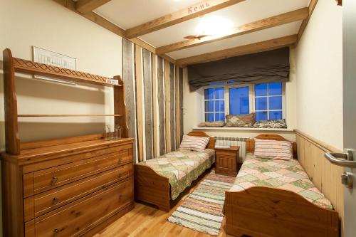 a bedroom with two bunk beds and a window at Hostel Pomor in Barentsburg