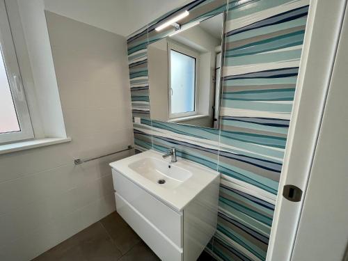 a bathroom with a sink and a mirror at Casa del Groto in Grado