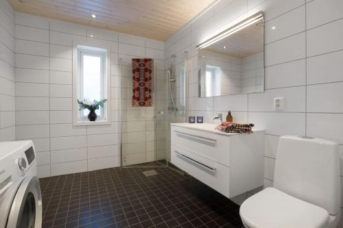 a white bathroom with a sink and a toilet at Bualie - Golsfjellet - Biking, swimmming, hiking. High standard. in Gol