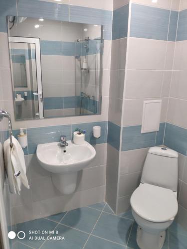 a bathroom with a toilet and a sink at Dolce Vita Residenza in Nesebar