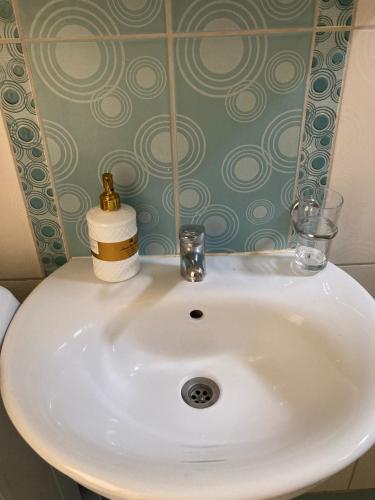a white sink with two glasses on top of it at Old Risan Apartment in Risan