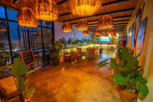 a restaurant with potted plants and chandeliers at Belci City Residence in Fethiye