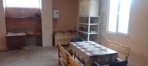 a kitchen with a table and chairs in a room at Sevan Backstage Garden in Sevan