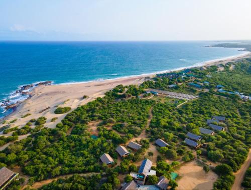 an aerial view of a beach with houses and the ocean at Jetwing Safari Camp in Yala