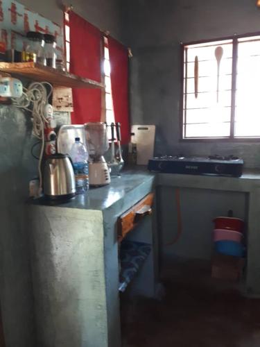 a kitchen with a refrigerator and a stove top oven at Karibu Paradaizi in Michamvi
