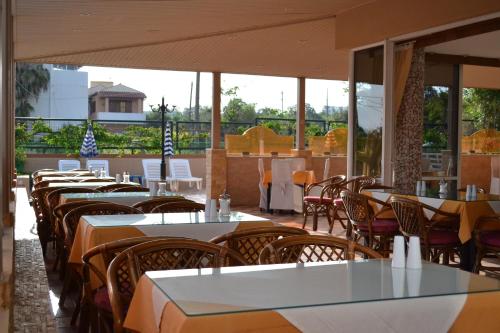 a row of tables and chairs in a restaurant at Palladion in Adelianos Kampos
