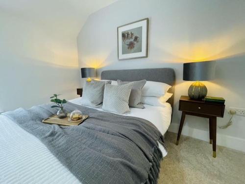 a bedroom with a bed with a tray on it at Charming Cottage close to M4 Bridgend in Bridgend