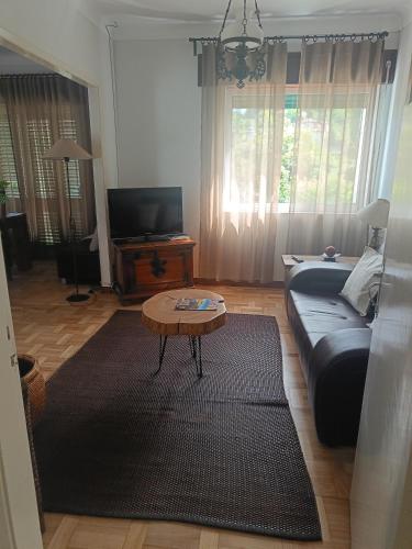 a living room with a couch and a coffee table at Casa Mió localizada em pleno centro histórico in Arcos de Valdevez