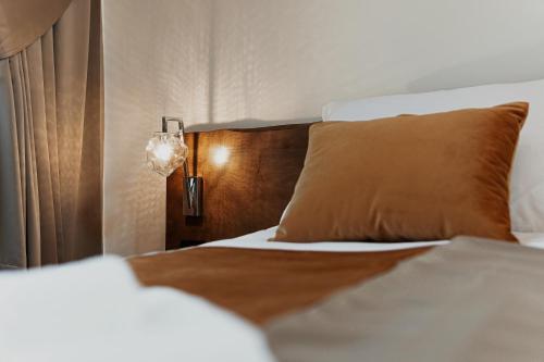 a bedroom with a bed with a pillow and a lamp at Toplik Village Resort in Lukavica