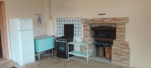 a kitchen with a stove and a brick fireplace at Sevan Garden Complex in Sevan