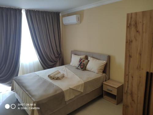 a bedroom with a bed with two towels on it at Dolce Vita Residenza in Nesebar