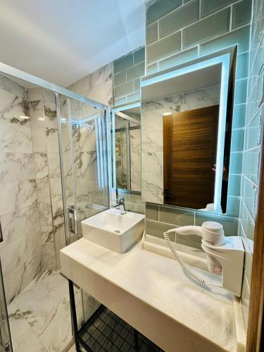 a bathroom with a sink and a mirror at Nice Royal Cıty in Istanbul