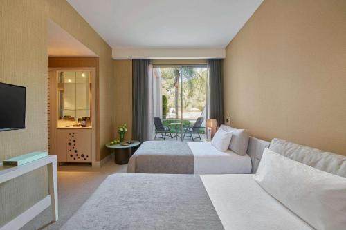 a hotel room with two beds and a television at Maxx Royal Belek Golf Resort in Belek