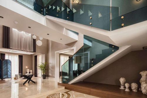 a staircase in a house with a blue wall at Maxx Royal Belek Golf Resort in Belek