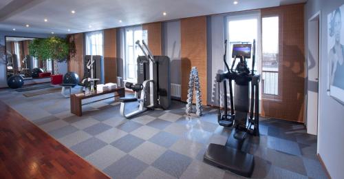 a gym with cardio equipment in a building at Lindner Hotel Hamburg am Michel, part of JdV by Hyatt in Hamburg