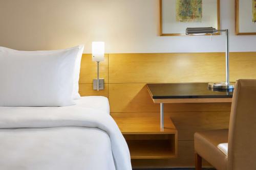 a hotel room with a bed and a desk at Lindner Hotel Dusseldorf Seestern, part of JdV by Hyatt in Düsseldorf